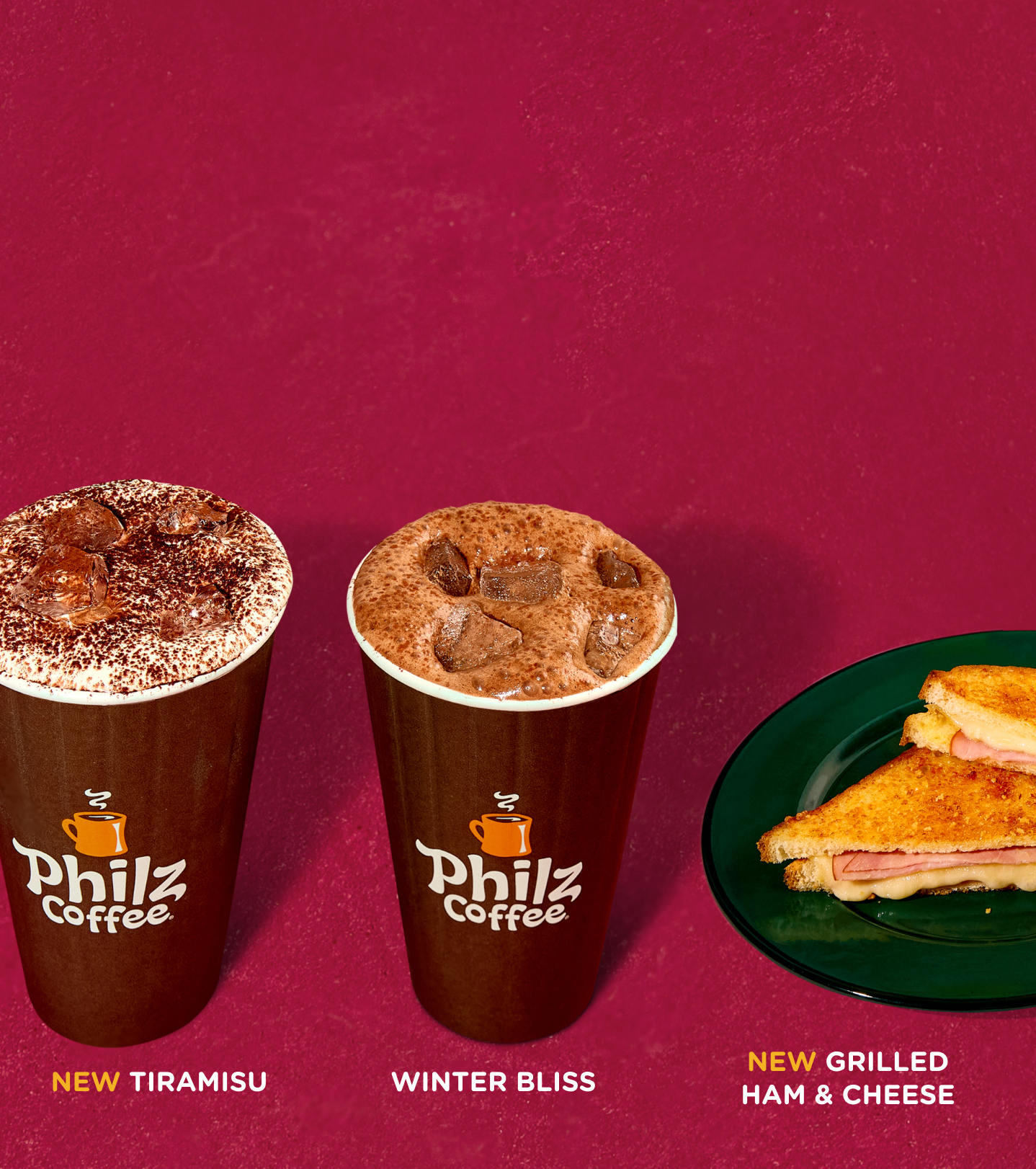 Two iced beverages with a grilled cheese and ham sandwich